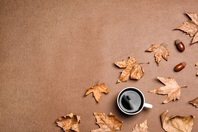 Flat lay composition with hot cozy drink and autumn leaves on color background. Space for text