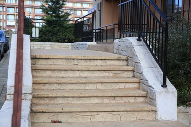 Photo of View of beautiful stone stairs with metal handrails outdoors