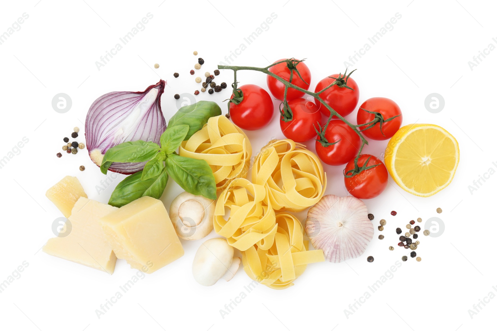 Photo of Uncooked fettuccine pasta and ingredients on white background, top view