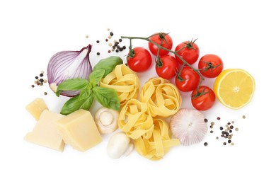 Uncooked fettuccine pasta and ingredients on white background, top view