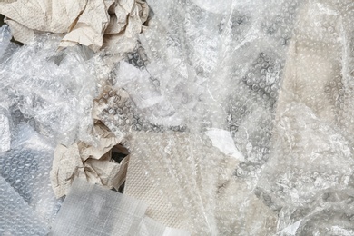 Photo of Pile of paper and plastic garbage as background, top view. Recycling problem