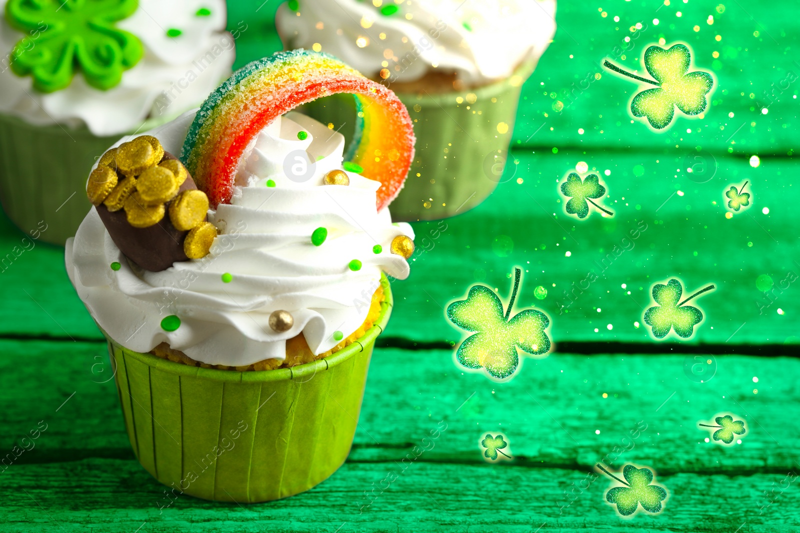 Image of St. Patrick's day. Tasty festively decorated cupcakes on green wooden table, closeup. Space for text