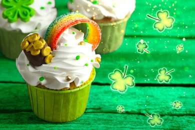 Image of St. Patrick's day. Tasty festively decorated cupcakes on green wooden table, closeup. Space for text