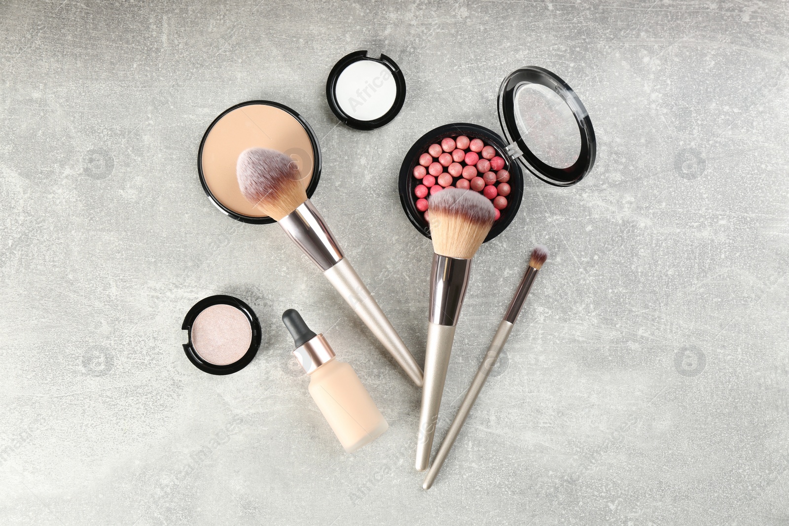 Photo of Flat lay composition with makeup brushes on grey stone table