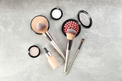 Photo of Flat lay composition with makeup brushes on grey stone table