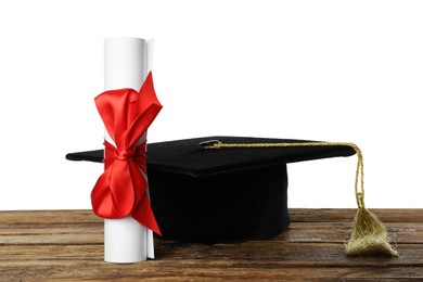 Graduation hat and diploma on wooden table against  white background