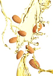 Image of Organic almond oil and tasty nuts flying on white background