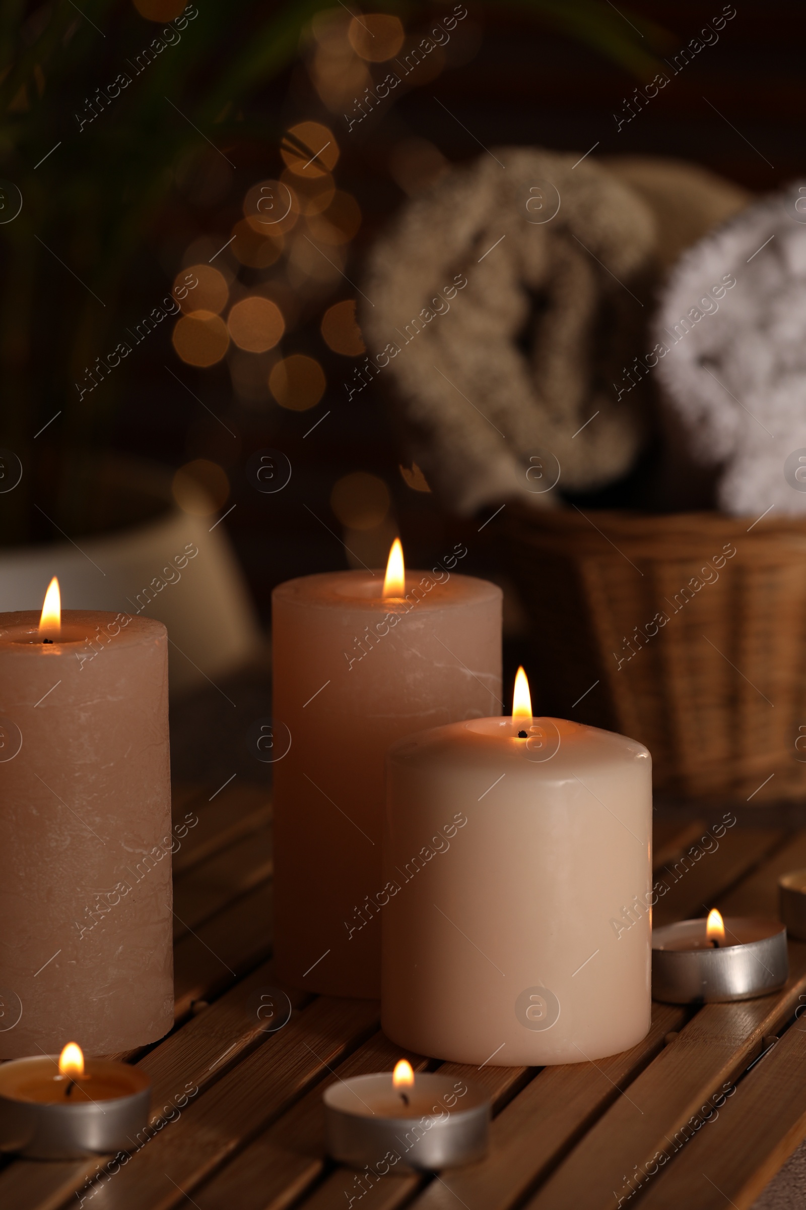 Photo of Spa composition with burning candles on wooden table