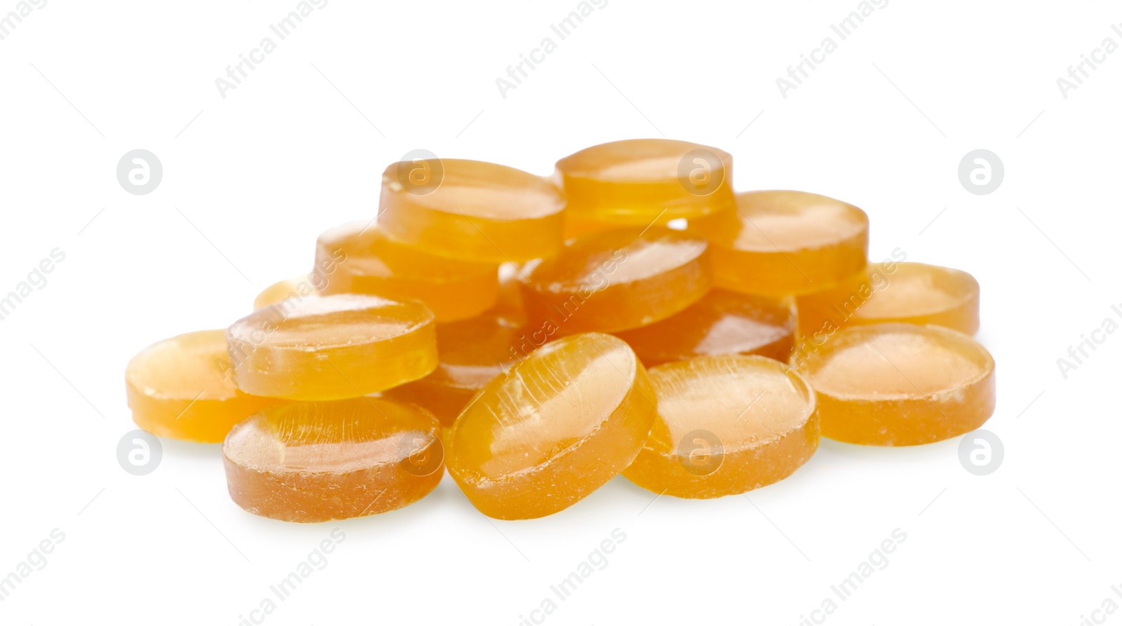 Photo of Many yellow cough drops on white background