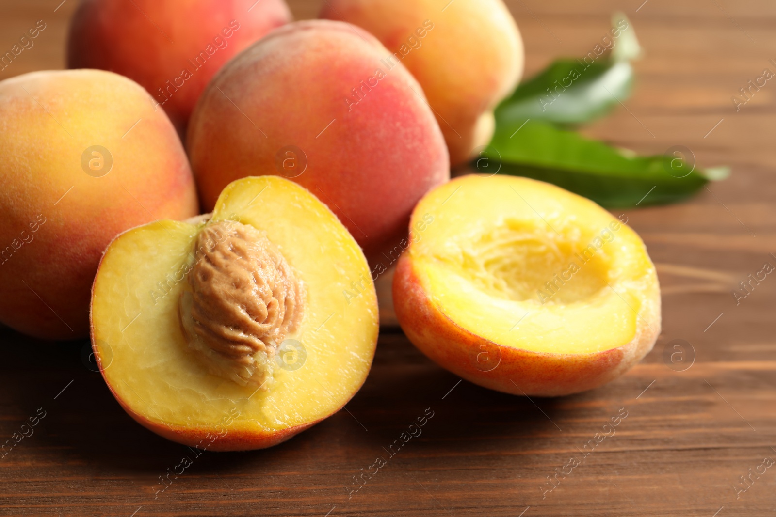 Photo of Fresh sweet peaches on wooden table, closeup