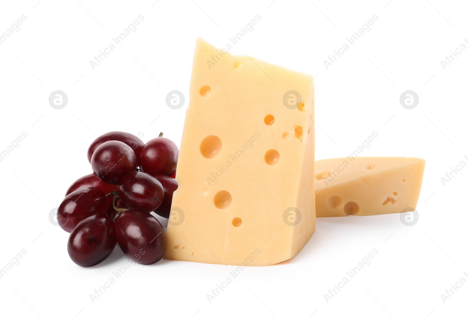 Photo of Pieces of delicious cheese and grapes isolated on white