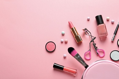 Photo of Flat lay composition with products for decorative makeup on pastel pink background