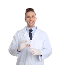 Photo of Male dentist holding tooth model on white background