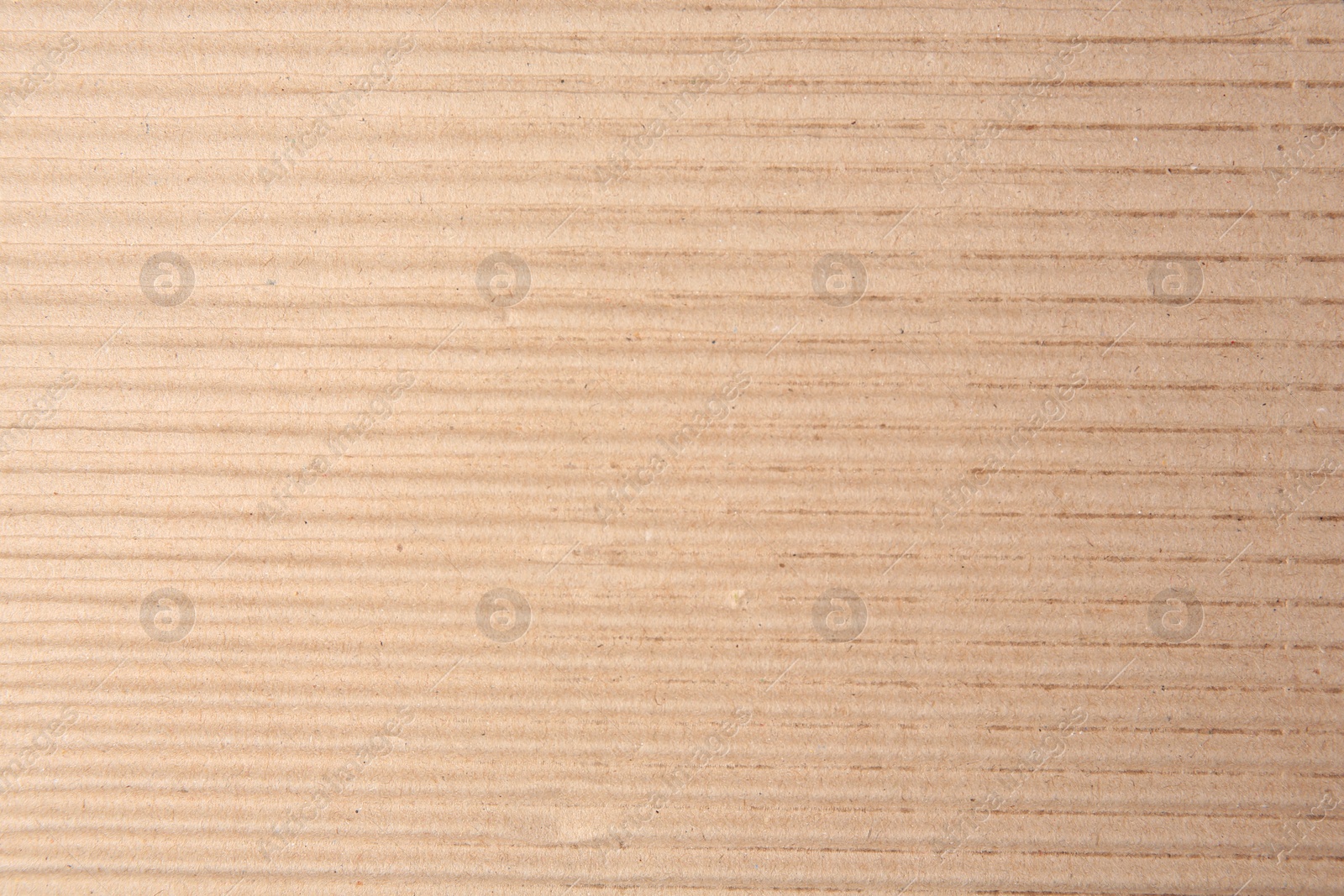 Photo of Texture of beige corrugated paper sheet as background, closeup