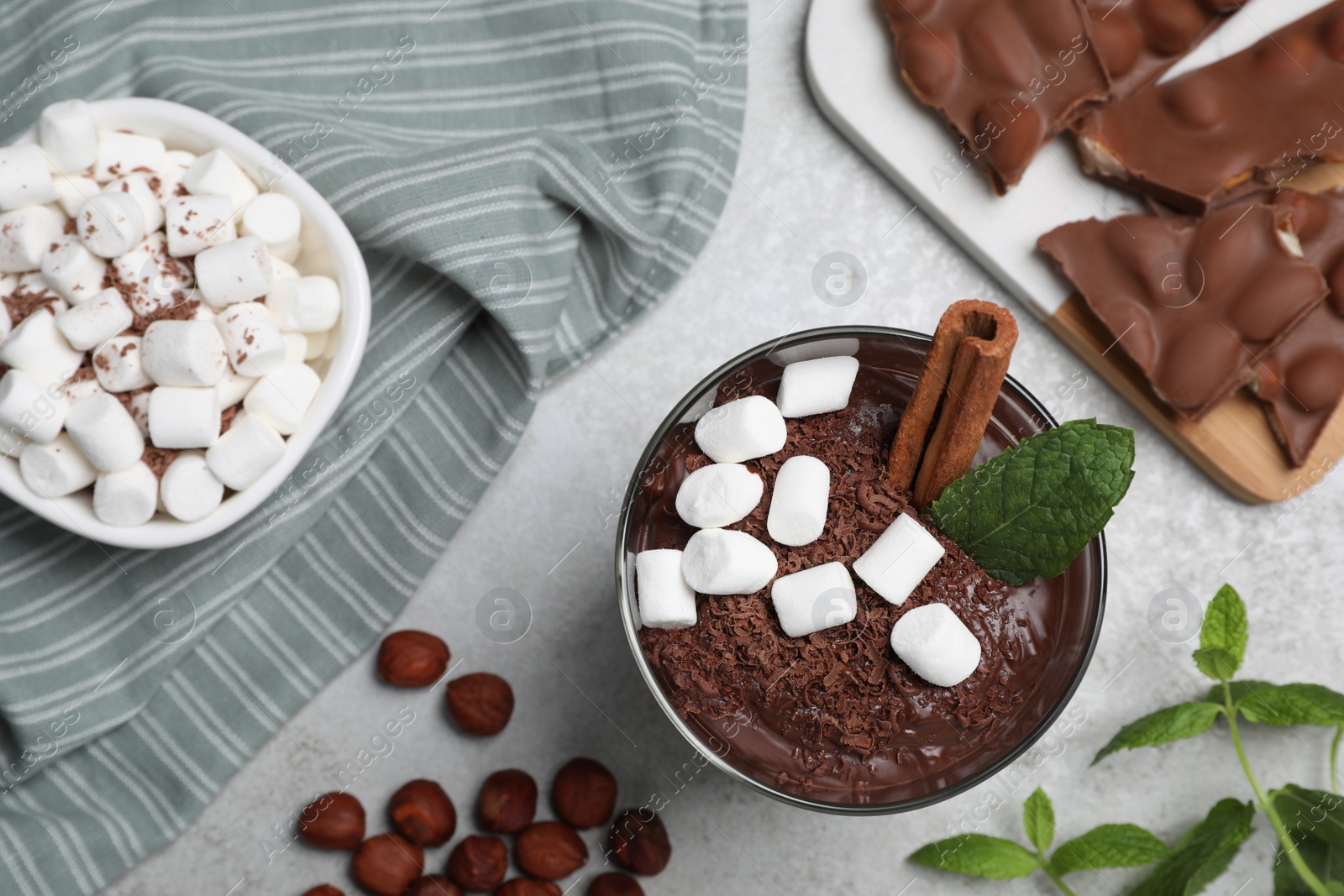 Photo of Flat lay composition with cup of delicious hot chocolate on light grey table