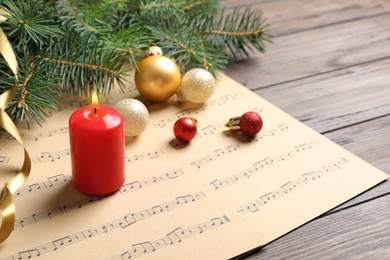 Photo of Composition with Christmas decorations and music sheets on table