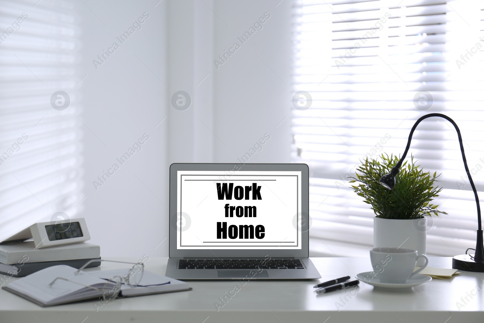 Image of Modern laptop on table in room. Work from home