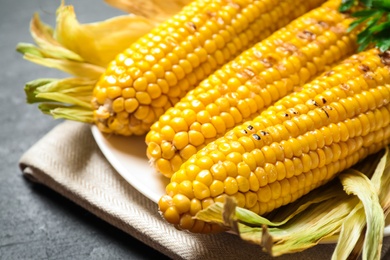 Tasty grilled corn on table, closeup view