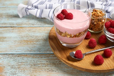 Tray with delicious yogurt, raspberries and granola on old wooden table. Space for text