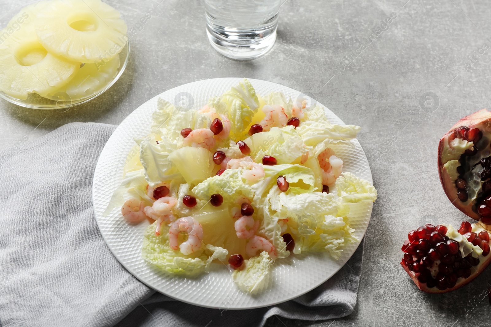 Photo of Delicious salad with Chinese cabbage, shrimps and pineapple served on grey table