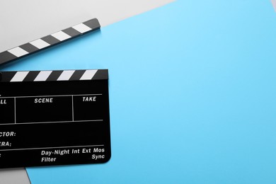 Photo of Clapperboard on color background, top view. Space for text