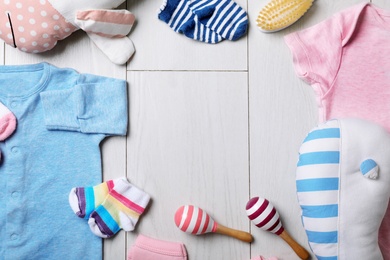 Photo of Flat lay composition with stylish baby clothes on wooden background. Space for text