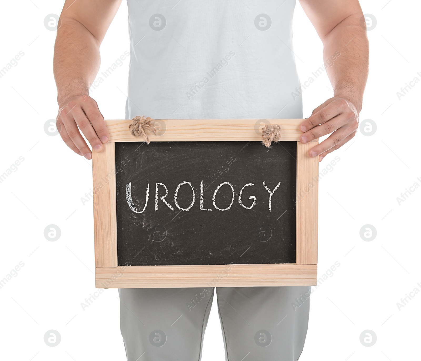 Photo of Young man holding chalkboard with word UROLOGY on white background