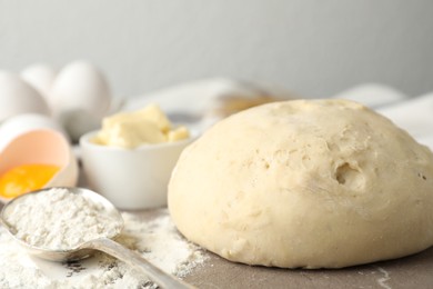 Photo of Wheat dough and products on table, closeup. Cooking pastries