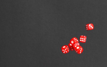 Photo of Many game dices falling on black background, space for text