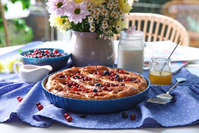 Photo of Delicious currant pie with fresh berries served on white table