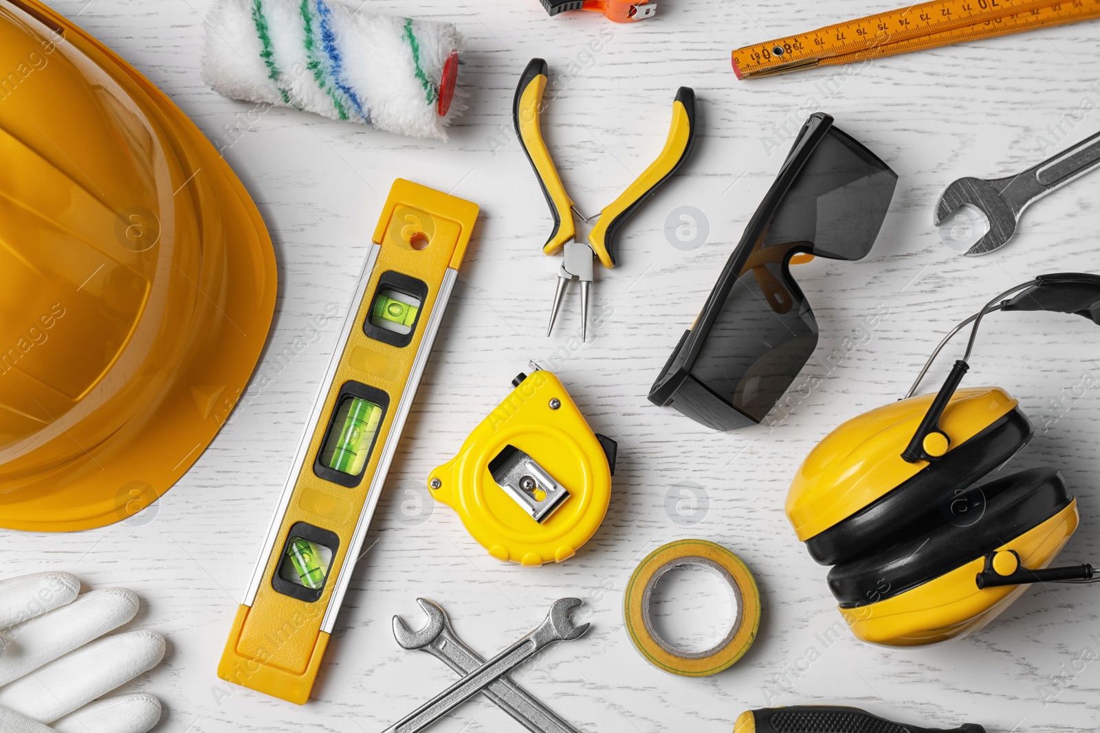 Photo of Flat lay composition with construction tools on white wooden background