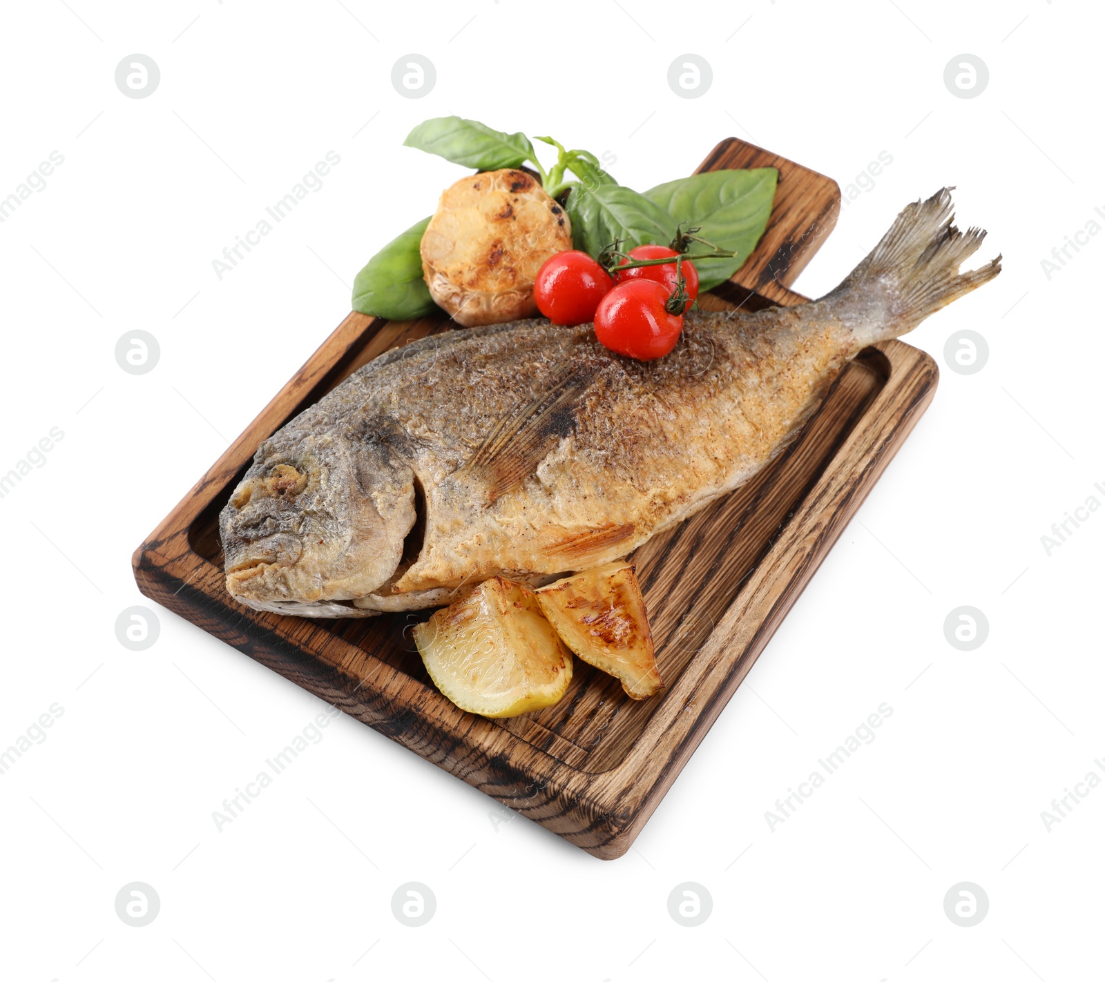 Photo of Delicious roasted dorado fish with vegetables, basil and lemon isolated on white