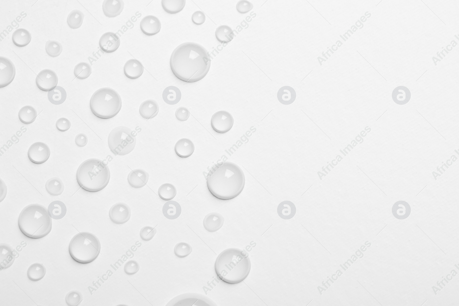 Photo of Water drops on white background, top view. Space for text