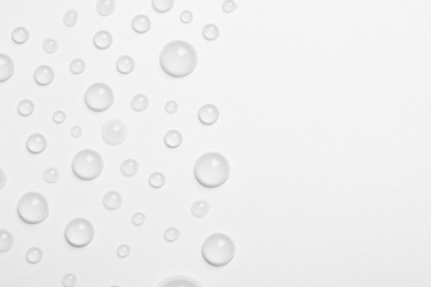 Water drops on white background, top view. Space for text