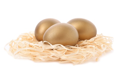 Golden eggs in nest on white background