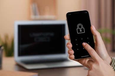 Woman unlocking smartphone with blocked screen indoors, closeup. Space for text