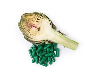 Photo of Fresh artichoke and pills isolated on white, top view