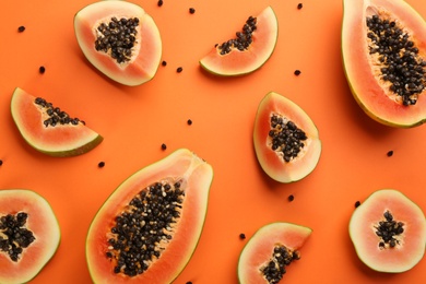 Fresh ripe papaya fruits on orange background, flat lay