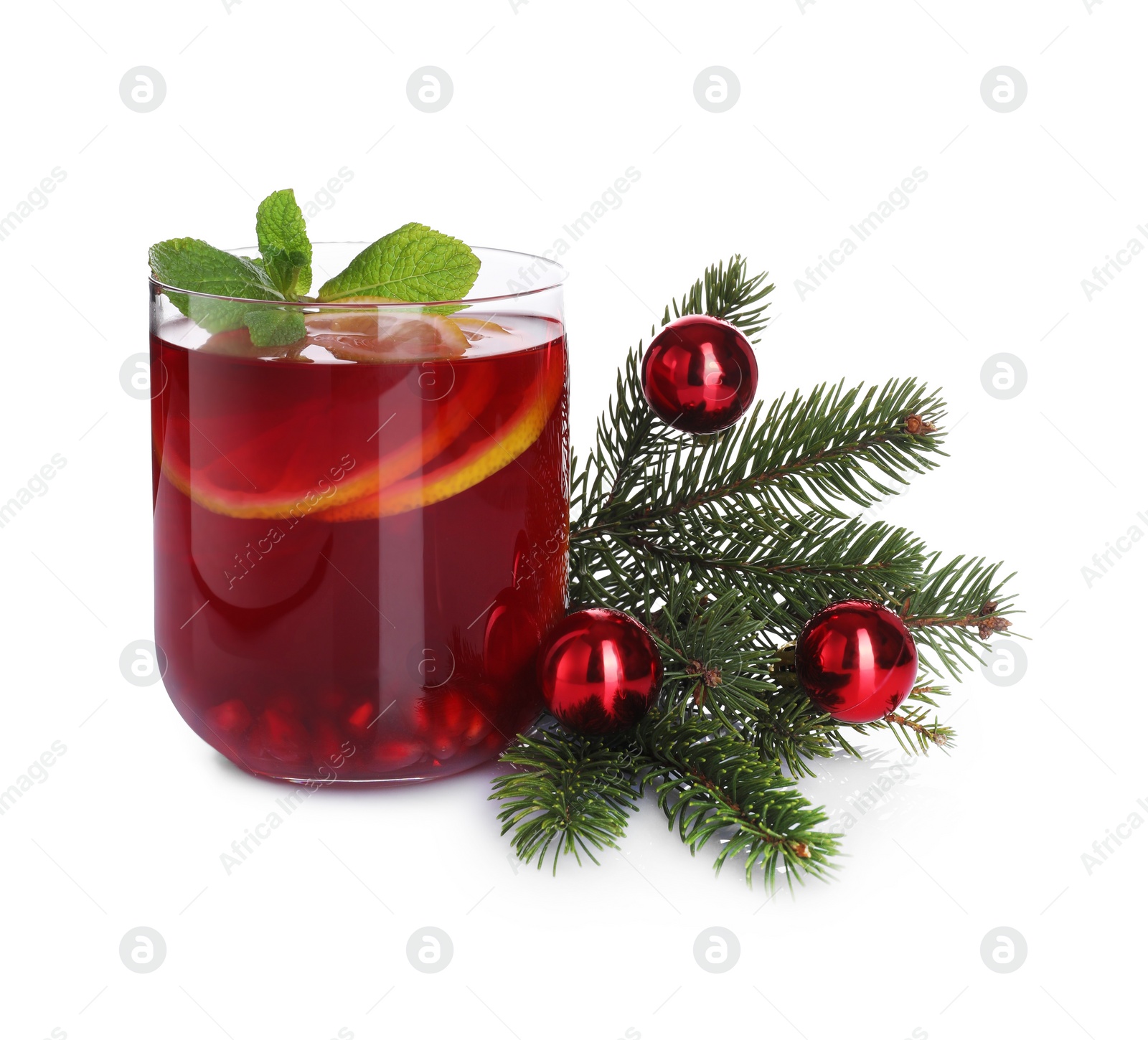Photo of Christmas Sangria drink in glass, fir branch and baubles on white background