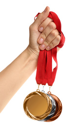 Photo of Woman holding medals on white background, closeup. Space for design
