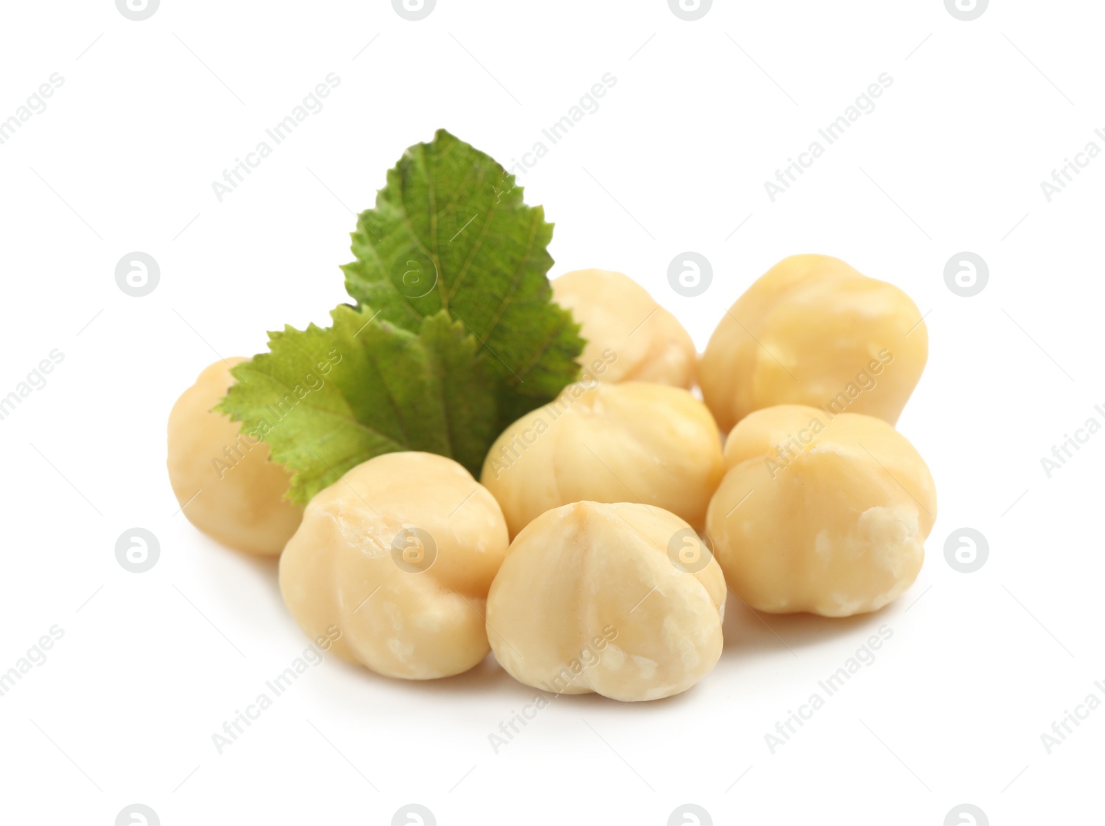 Photo of Tasty organic hazelnuts and leaves on white background