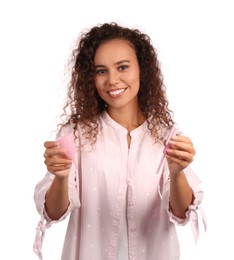 Photo of Young African American woman with menstrual cup and tampon on white background