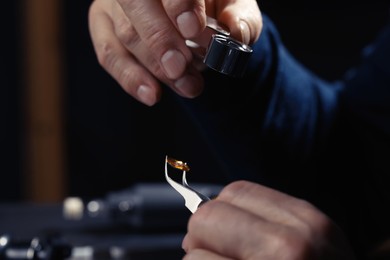 Professional jeweler working with gemstone, closeup view