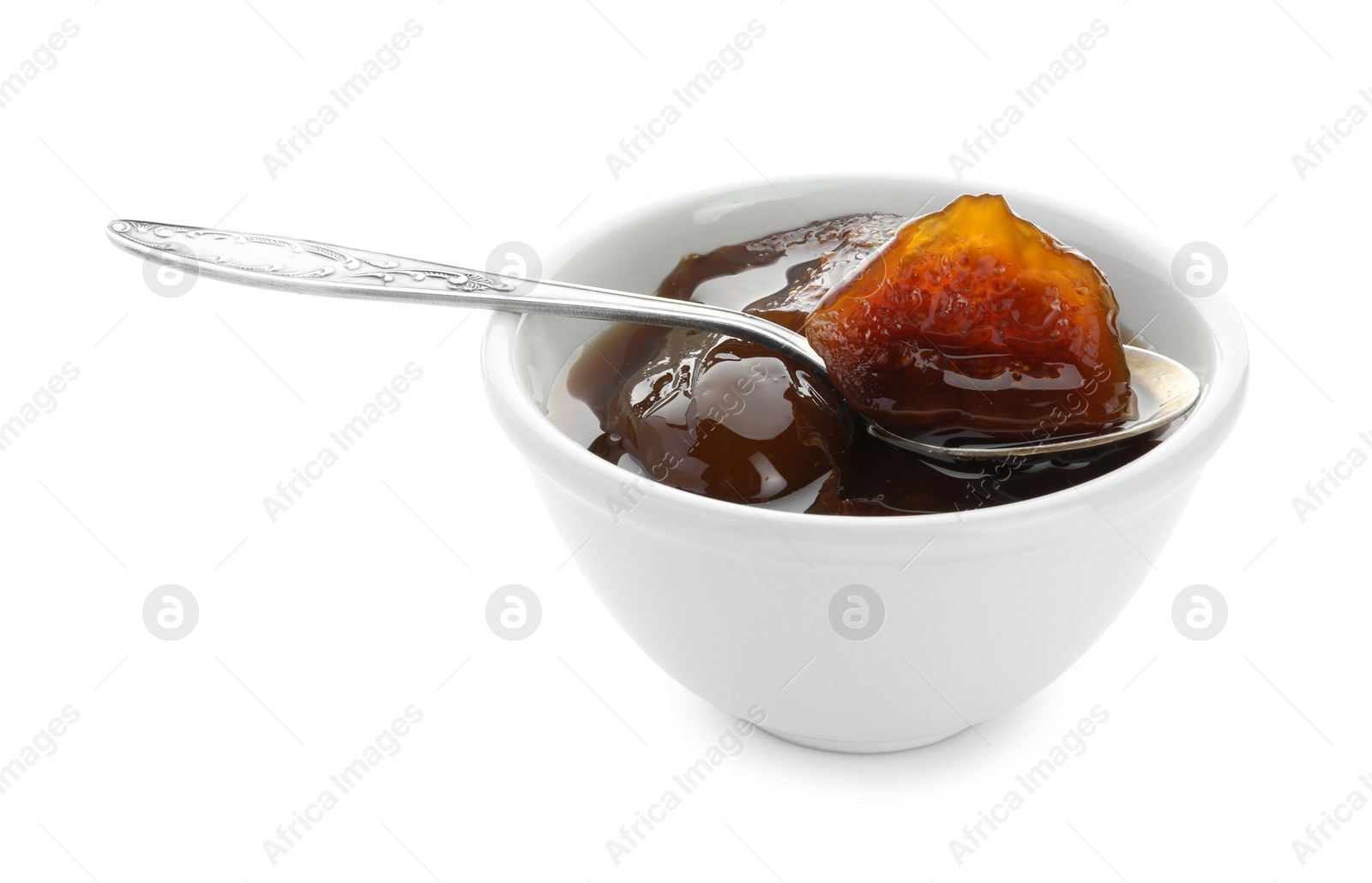 Photo of Bowl of tasty sweet fig jam and spoon isolated on white