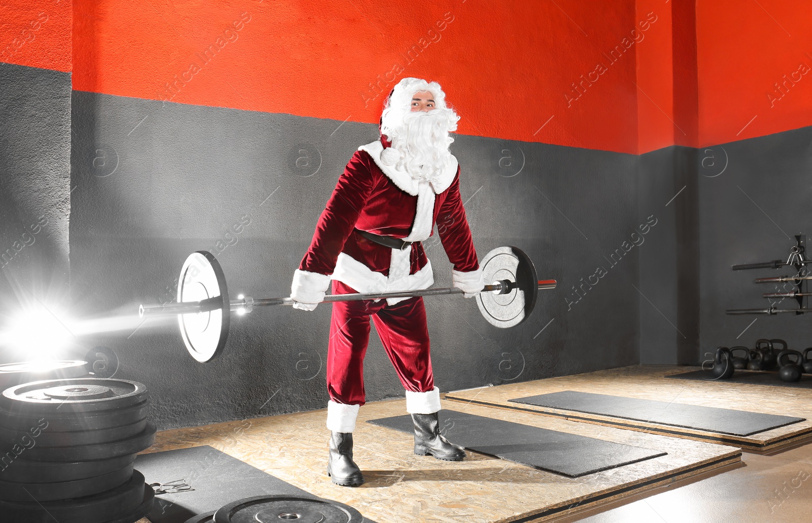 Photo of Young Santa Claus training in modern gym