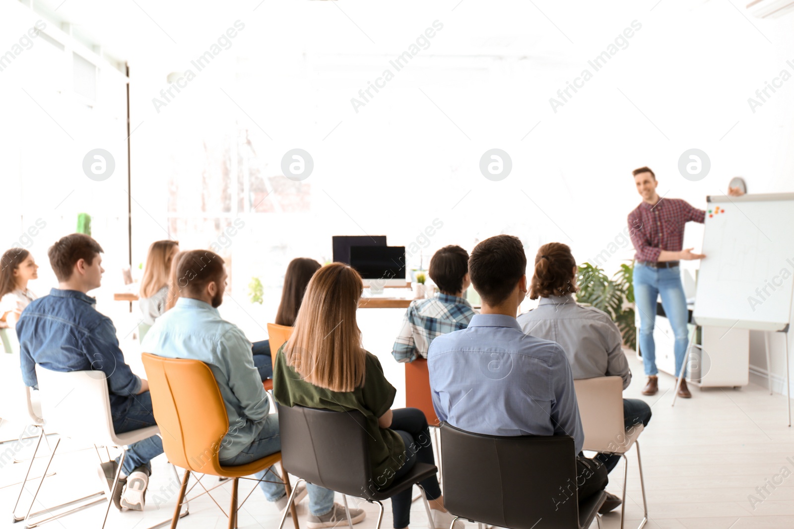 Photo of Male business trainer giving lecture in office