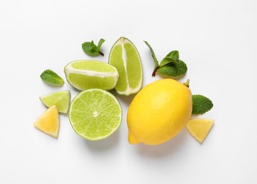 Photo of Fresh ripe lemons, limes and mint leaves on white background, top view