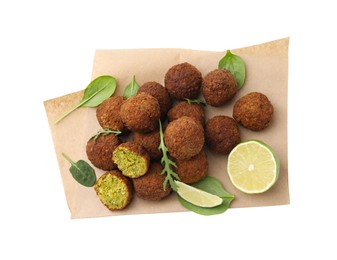 Photo of Delicious falafel balls, basil, arugula and lime isolated on white, top view