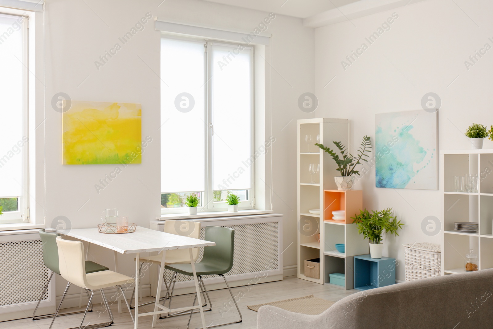 Photo of Stylish apartment interior with dining table and sofa