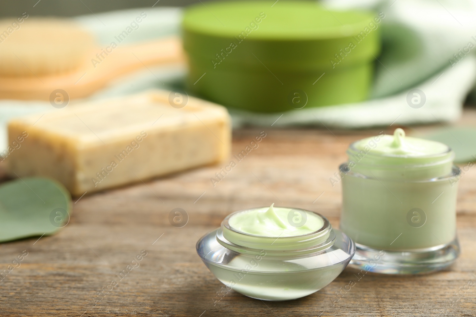 Photo of Hand cream jars on wooden background. Natural cosmetic